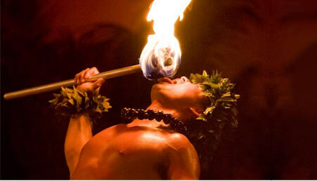 A fire-knife dancer eats fire at Aloha-kai Luau, one of the Oahu luaus.