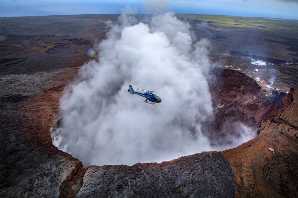 Ohau Helicopter tours to the Big Island, a helicopter hovers above an active volcano