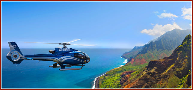 Airbus EcoStar touring helicopter flies above the Hawaiian coastline 