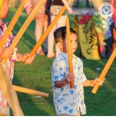 Boy participates in cultural activities at Diamond Head Luau Waikiki