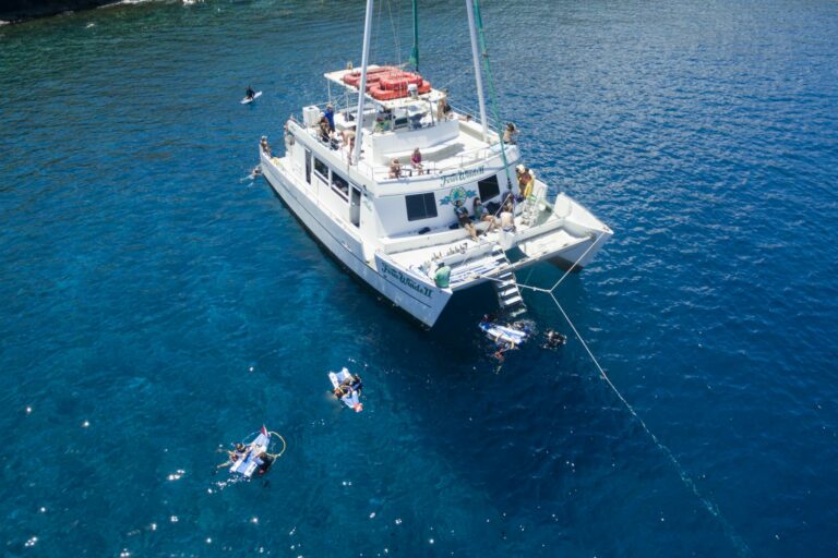 Tour Hawaii's Afternoon Snorkel Tour on the Four Winds Boat with snorkelers resting on boat and in water