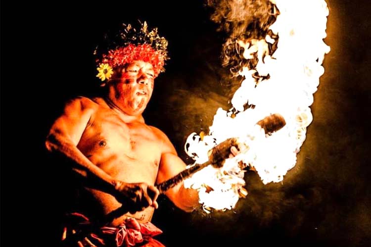 A fire knife is lit by Chief Sielu at Oahu's best luau