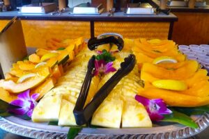 Locally sourced fresh fruits, pineapple and papaya served at a Hawaiian Luau buffet