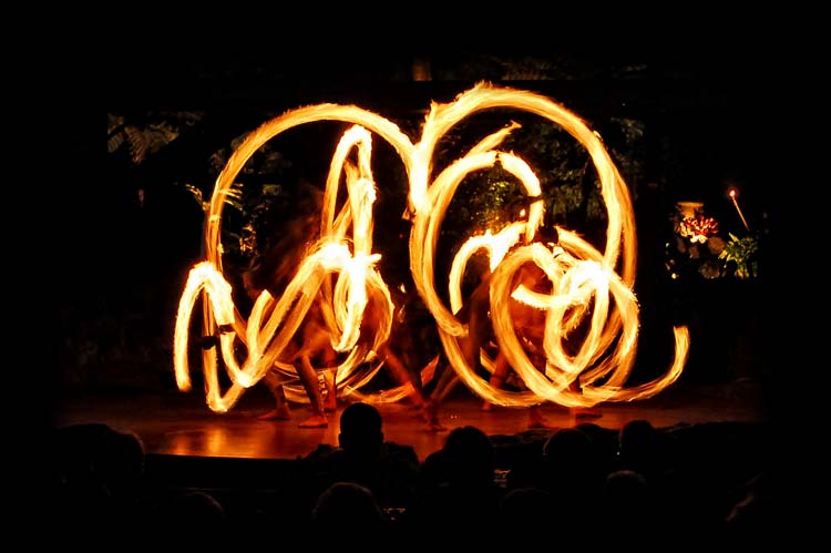 Fire knife dances spin flames on stage at Luau Kalamaku, the best of Kauai luaus