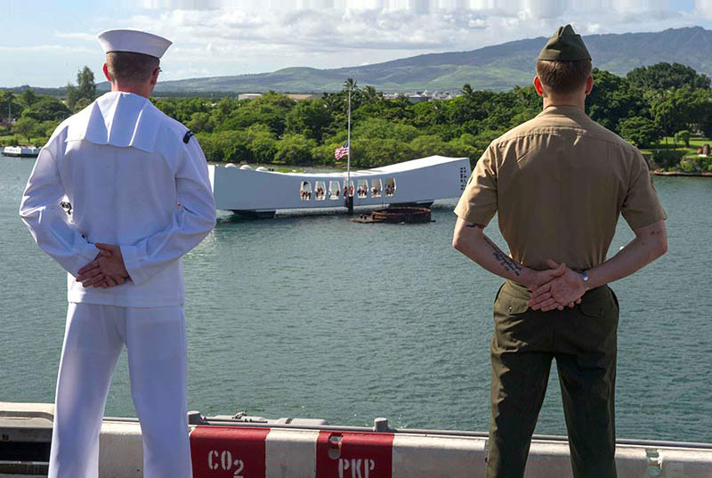 Enlisted men stand watch over the USS Arizona Memorial