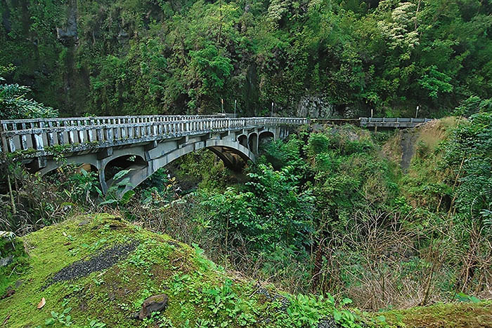 An old concrete bridge spans a tropical gulch on the Hana Highway in Maui. 