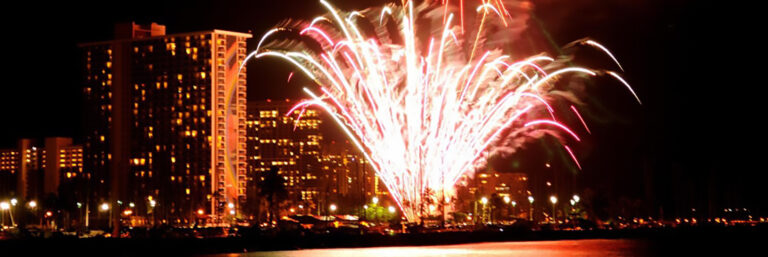 A huge fountain of fireworks on the beach, as seen from a dinner and sunset cruise, Waikiki Hawaii.